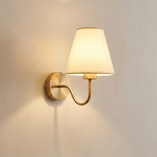 Myrtle wall sconce lit on a warm plaster interior wall