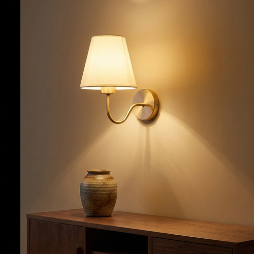Myrtle wall sconce above a walnut console with a stoneware vase