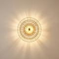Sona wall light casting a soft wash of light on a plaster wall