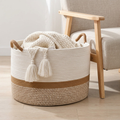 Larch cotton blanket basket beside a linen armchair holding a folded throw
