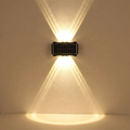 Blaeb wall light casting a soft wash of light on a plaster wall