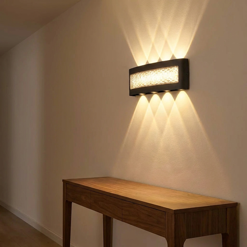 Wall sconce above a walnut console in a hallway at night