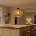 Rattan pendant light lit above a kitchen island