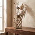 Grit glass vase on a walnut console with dried stems