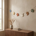Shoal wall hanging above a walnut console in a calm neutral room