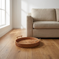 Rattan storage basket on oak flooring beside a linen sofa